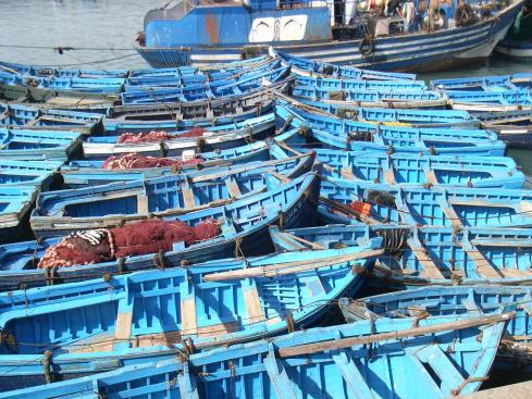 Small blue fishing boats in port